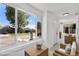 Cozy sunroom featuring whitewashed brick, large windows, and comfortable seating, virtually staged at 4745 N Clay St, Denver, CO 80211