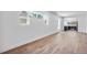 Bright living room with hardwood floors, white walls, and a view into the adjacent, remodeled kitchen at 4745 N Clay St, Denver, CO 80211