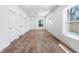 Open concept living room with wood floors, white walls, and lots of natural light from the windows at 4745 N Clay St, Denver, CO 80211