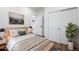 Comfortable main bedroom with neutral decor, wood floors, and an ensuite bathroom at 4745 N Clay St, Denver, CO 80211