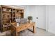 Charming home office with a rustic desk, bookshelves, and a cozy rug for a productive work space at 4745 N Clay St, Denver, CO 80211