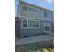 Exterior view of the backyard with sliding doors to a patio and windows offering natural light at 23014 Milford Ln, Parker, CO 80138