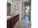 Bathroom featuring a double sink vanity with a granite countertop and decorative lighting at 23014 Milford Ln, Parker, CO 80138