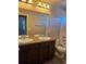 Bathroom featuring a double sink vanity with a granite countertop and a shower-tub combination at 23014 Milford Ln, Parker, CO 80138
