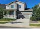 Charming two-story home featuring a covered porch, attached two-car garage, and a well-maintained front yard at 23014 Milford Ln, Parker, CO 80138