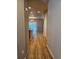 Hallway featuring gleaming wood floors leading to a bright dining area, showcasing an open floor plan at 23014 Milford Ln, Parker, CO 80138