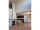 Open living space featuring a cozy fireplace, hardwood floors, and a modern kitchen with stainless steel appliances at 23014 Milford Ln, Parker, CO 80138