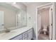Bright bathroom featuring modern vanity with stone countertop and well-lit with large mirror at 38 Morgan Cir, Erie, CO 80516