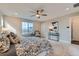 Bright bedroom with large windows offering beautiful views, ceiling fan, and neutral decor for a peaceful ambiance at 38 Morgan Cir, Erie, CO 80516
