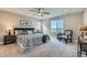 This spacious bedroom features neutral tones, large windows, and a ceiling fan for a relaxing retreat at 38 Morgan Cir, Erie, CO 80516