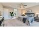 Relaxing bedroom with ensuite bathroom access, neutral colors, ceiling fan, and modern furnishings at 38 Morgan Cir, Erie, CO 80516