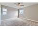 This expansive bedroom offers abundant natural light, neutral tones, and a ceiling fan, creating a serene retreat at 38 Morgan Cir, Erie, CO 80516