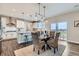Elegant dining room with stylish lighting and access to the outdoor space at 38 Morgan Cir, Erie, CO 80516