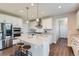 Modern kitchen features white cabinets, stainless steel appliances, and a spacious island at 38 Morgan Cir, Erie, CO 80516