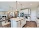 Open-concept kitchen with stainless appliances, island, and dining area, ideal for entertaining at 38 Morgan Cir, Erie, CO 80516