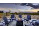Outdoor patio with a fire pit and comfortable seating, perfect for enjoying the sunset at 38 Morgan Cir, Erie, CO 80516
