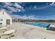 Beautiful community pool and clubhouse on a sunny day with tables, chairs and neighborhood views at 38 Morgan Cir, Erie, CO 80516