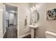 This charming powder room offers a pedestal sink, oval mirror, and stylish lighting, creating a welcoming space at 38 Morgan Cir, Erie, CO 80516