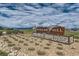 Community entrance sign with stone landscaping and a view of the neighborhood on a cloudy day at 38 Morgan Cir, Erie, CO 80516