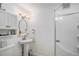Clean, bright bathroom with pedestal sink, vanity cabinet, and walk-in shower at 9640 Moss Rose Cir, Highlands Ranch, CO 80129