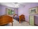 Charming bedroom with two twin beds, ceiling fan, and a decorative dresser at 9640 Moss Rose Cir, Highlands Ranch, CO 80129