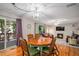 Charming dining area with hardwood floors, an elegant light fixture, and access to an outdoor patio at 9640 Moss Rose Cir, Highlands Ranch, CO 80129