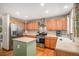 Well-lit kitchen featuring stainless steel appliances, wood cabinets and hardwood floors at 9640 Moss Rose Cir, Highlands Ranch, CO 80129