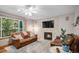 Inviting living room with a stone fireplace, hardwood floors, and a view of the outdoor deck at 9640 Moss Rose Cir, Highlands Ranch, CO 80129