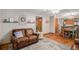 Comfortable living room featuring hardwood floors, a stone fireplace, and an open layout at 9640 Moss Rose Cir, Highlands Ranch, CO 80129