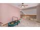 Bright upstairs landing featuring neutral carpet, pink walls, and an open stairwell at 9640 Moss Rose Cir, Highlands Ranch, CO 80129