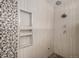 Custom walk-in shower features stone details, built-in niche, and modern fixtures at 9640 Moss Rose Cir, Highlands Ranch, CO 80129