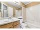 Bathroom featuring a single sink vanity, a large mirror, and a shower-tub combo at 11386 Eaton Way, Westminster, CO 80020