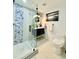 Clean bathroom with a glass shower, toilet, and modern vanity at 1931 S Locust St, Denver, CO 80224