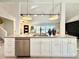 Sleek kitchen island with white shaker cabinets and stainless steel appliances at 1931 S Locust St, Denver, CO 80224