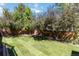 Beautifully maintained backyard with trees, lush green grass, and a privacy fence at 9546 High Cliffe St, Highlands Ranch, CO 80129