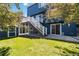 Expansive backyard with lush lawn, patio and multi-level deck with stairs at 9546 High Cliffe St, Highlands Ranch, CO 80129