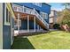 Expansive backyard with lush lawn, a deck with stairs, and manicured landscaping at 9546 High Cliffe St, Highlands Ranch, CO 80129