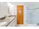 Bathroom featuring granite counters, a wood door, and a glass shower enclosure at 9546 High Cliffe St, Highlands Ranch, CO 80129