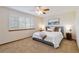 Comfortable bedroom with neutral decor, large windows, and a cozy bed at 9546 High Cliffe St, Highlands Ranch, CO 80129
