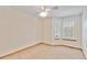 Bedroom with neutral carpet, two windows, and a ceiling fan at 9546 High Cliffe St, Highlands Ranch, CO 80129