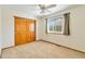 Bedroom with carpet, window and a closet with wood doors at 9546 High Cliffe St, Highlands Ranch, CO 80129