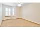 Bedroom with neutral carpet, two windows, and a ceiling fan at 9546 High Cliffe St, Highlands Ranch, CO 80129