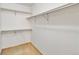 Walk-in closet featuring built-in metal storage racks and neutral carpeting at 9546 High Cliffe St, Highlands Ranch, CO 80129