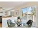 Bright dining area with a glass table, comfortable seating, and access to an outdoor deck at 9546 High Cliffe St, Highlands Ranch, CO 80129