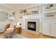 Cozy fireplace with built-in shelving, stylish decor, and comfortable seating in a bright living space at 9546 High Cliffe St, Highlands Ranch, CO 80129