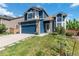 Inviting two-story home with blue siding, brick accents, well-manicured lawn, and attached two-car garage at 9546 High Cliffe St, Highlands Ranch, CO 80129
