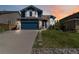 Charming two-story home with a well-manicured lawn, stepping stones, and a two-car garage at 9546 High Cliffe St, Highlands Ranch, CO 80129