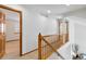 Hallway with wood railing, and views into other rooms at 9546 High Cliffe St, Highlands Ranch, CO 80129