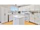 Bright kitchen featuring white cabinets, an island, and modern appliances at 9546 High Cliffe St, Highlands Ranch, CO 80129
