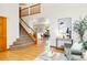 Open-concept living area with hardwood floors, staircase, and views of the dining room at 9546 High Cliffe St, Highlands Ranch, CO 80129